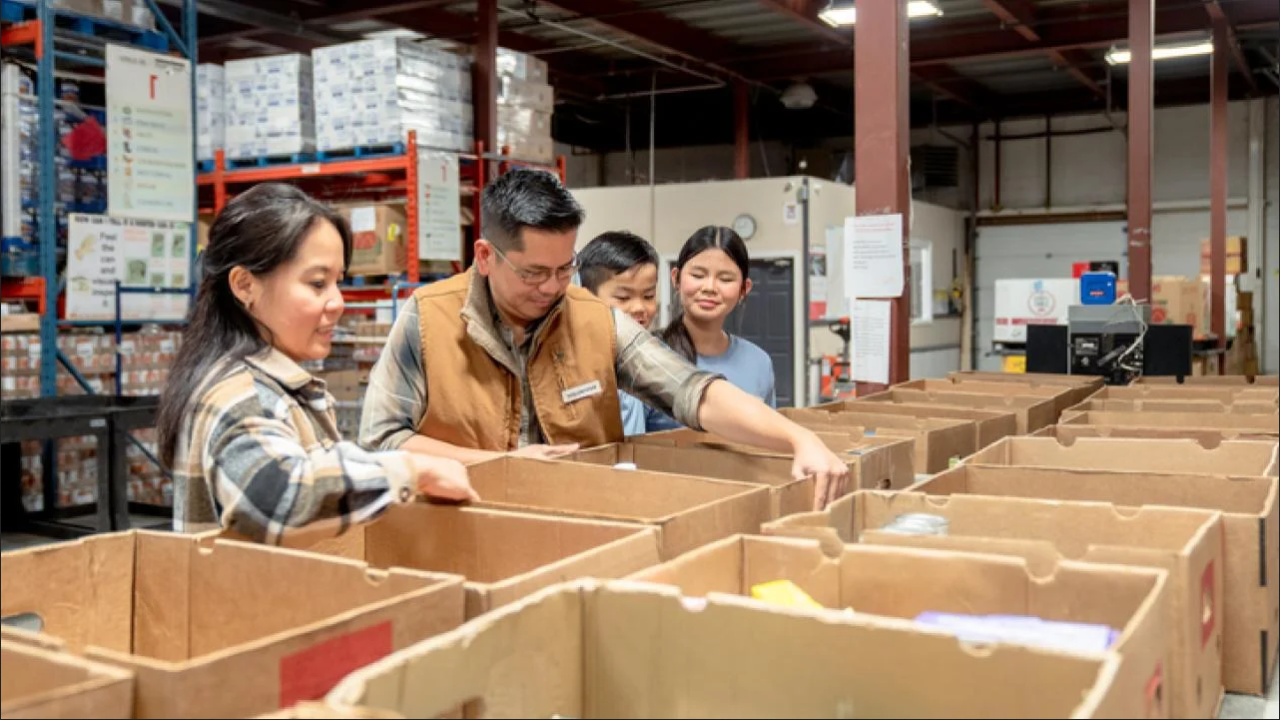 UC Davis researchers check over boxes of food from a foodbank